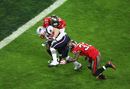 Wes Welker is tackled by Sabby Piscitelli