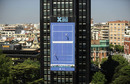 Acrobats play tennis on the side of a building
