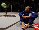 Georges St-Pierre looks on as Yves Jabouin trains in the backround 