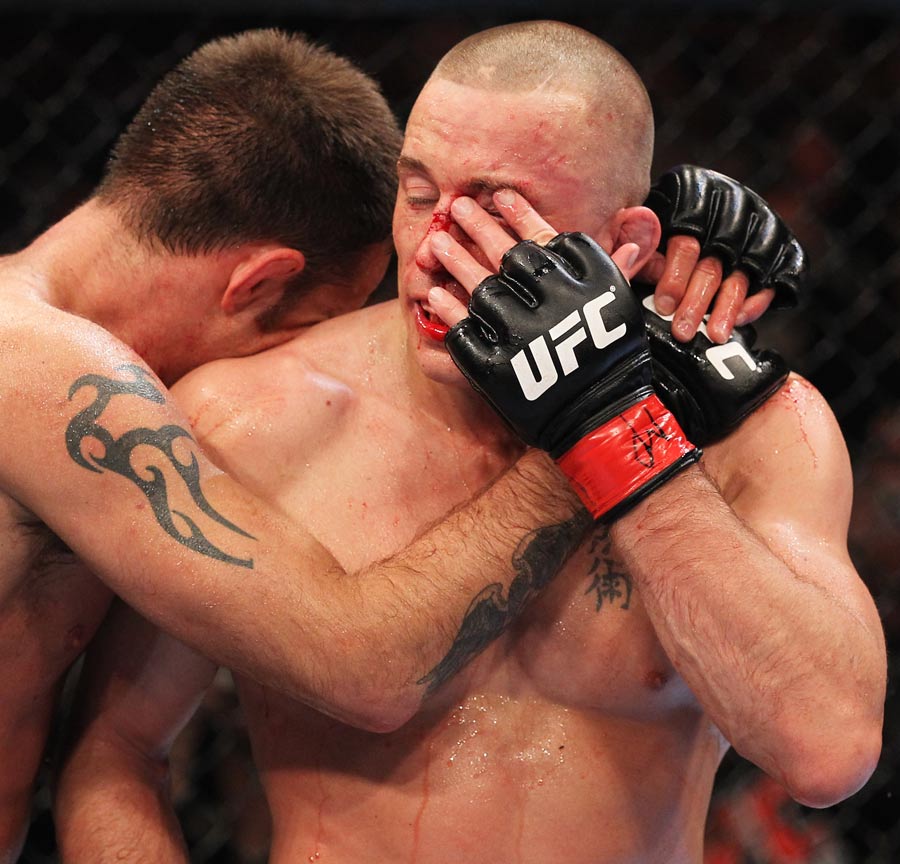 Georges St-Pierre is hugged by Jake Shields