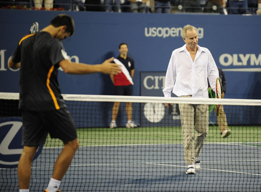 Novak Djokovic shares a joke with John McEnroe