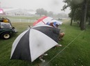 Fans take cover from the rain