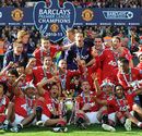 Manchester United players celebrate winning the title