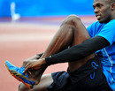 Usain Bolt puts on his spikes