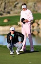 Ian Poulter looks on as Paul Casey lines up a putt