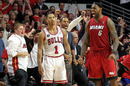 Derrick Rose of Chicago Bulls looks on dejected as LeBron James celebrates victory
