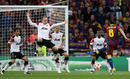 Wayne Rooney attempts to block a shot from Andres Iniesta