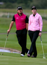 Graeme McDowell watches the action with Paula Creamer