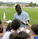Mario Balotelli signs autographs during Italy training