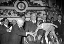 Jules Rimet holds the urn for his grandson Yves as he makes the draw for the World Cup