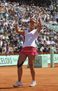 Li Na roars with delight after winning the match