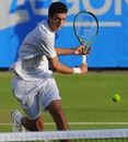 James Ward plays a backhand against Janko Tipsarevic