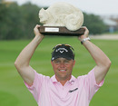 Cameron Beckman holds the Chameleon-shaped trophy after winning the Mayakoba Golf Classic
