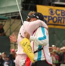 Ian Poulter embraces his caddy after claiming victory