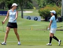 Michelle Wie and Ai Miyazato share a joke during practice 
