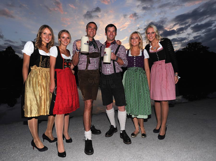 Marco Kaussler and Paul Casey share beers as they wear the traditional lederhosen costumes at the player party
