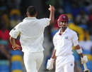 Praveen Kumar celebrates the wicket of Lendl Simmons