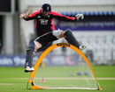 James Anderson leaps over a catching net during practice