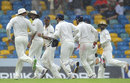 The Indian fielders hurry off the field as the rain comes down