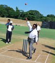 Sri Lanka Cricket chairman Somachandra de Silva sends down the first ball at the Pallekele Stadium
