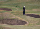 Dustin Johnson casts his eye over the bunkers