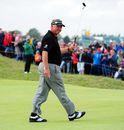Darren Clarke picks up his ball after getting a birdie on the the second hole