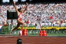 Florence Griffith-Joyner celebrates victory in the 100m