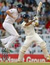 Ian Bell takes evasive action as Mahendra Singh Dhoni crunches the ball through the off side