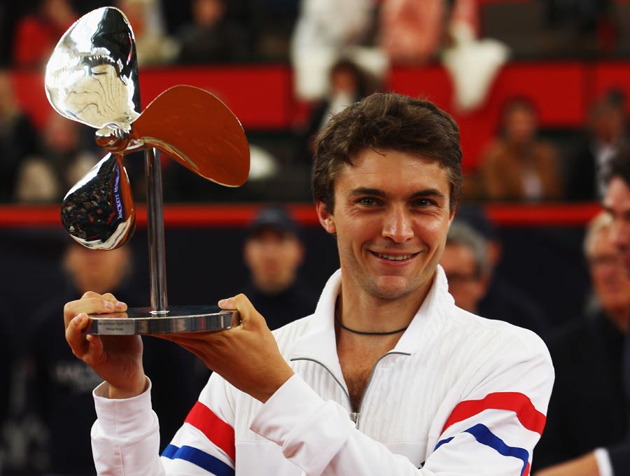 Gilles Simon celebrates with the cup after winning against Nicolas Almagro