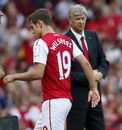 Jack Wilshere is watched by Arsene Wenger as he leaves the pitch 