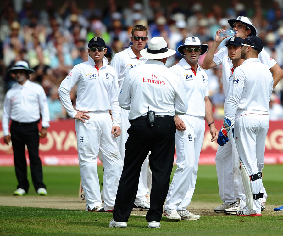 England's players talk to the umpire after a failed review 
