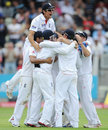 Alastair Cook joins the victorious team huddle