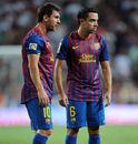 Xavi Hernandez and Lionel Messi line up a free kick