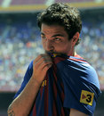 Cesc Fabregas kisses the badge after signing for Barcelona