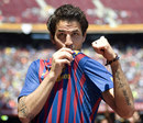 Cesc Fabregas kisses the badge after signing for Barcelona