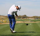 First round leader Camilo Villegas tees off as galleries move in the distance