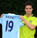 Samir Nasri poses with his new Manchester City shirt