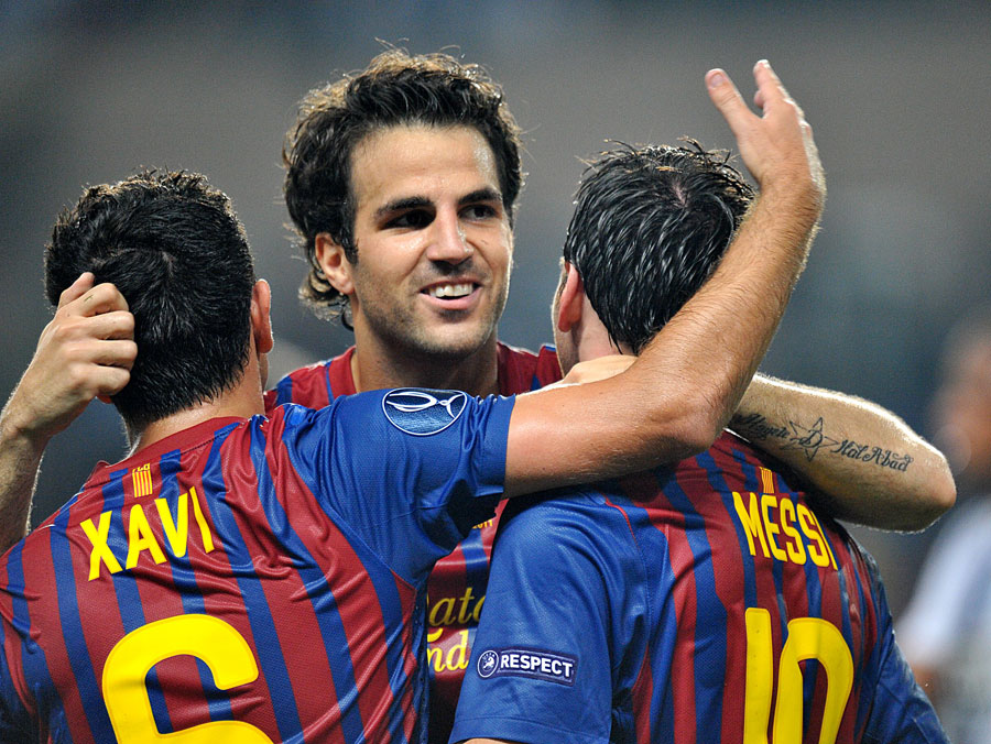 Cesc Fabregas celebrates with Xavi and Lionel Messi