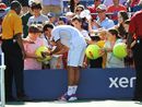 Novak Djokovic signs autographs for his fans
