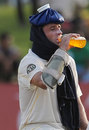 Michael Hussey takes a break from the heat and humidity