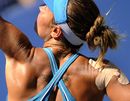Kateryna Bondarenko stretches for a serve