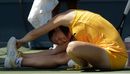 Jelena Jankovic stretches out her back