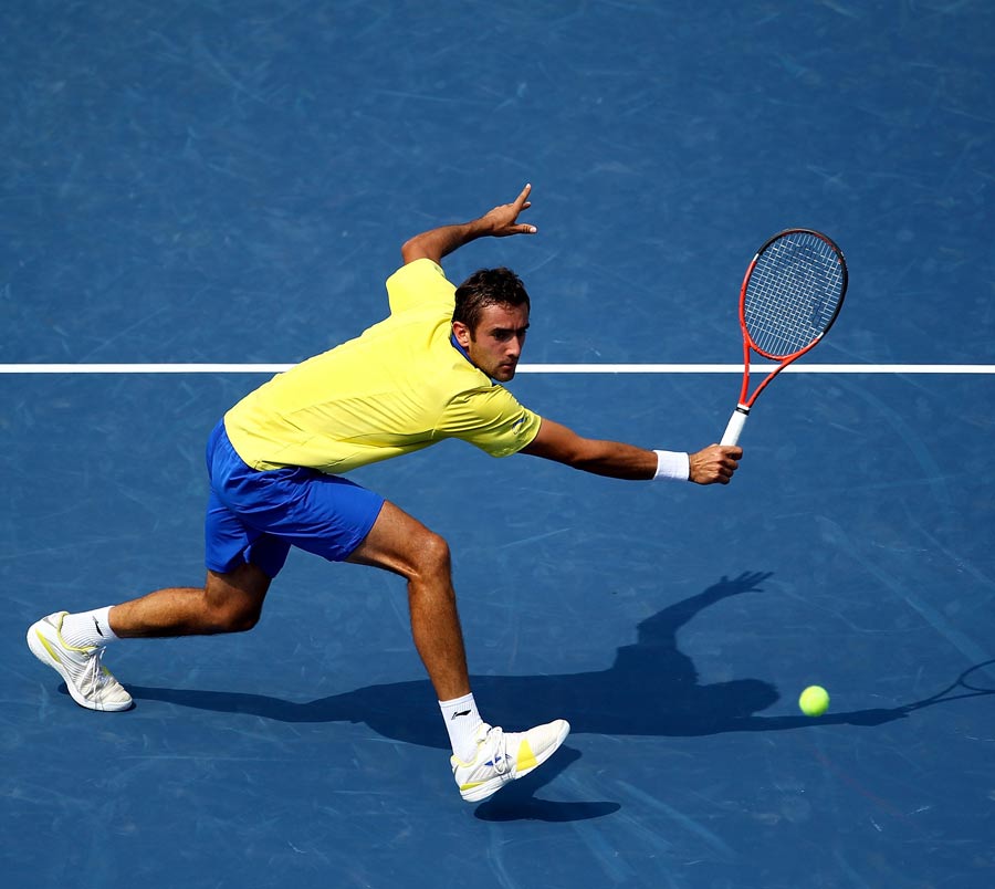 Marin Cilic stoops for a volley