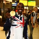 Mo Farah smiles with his gold medal