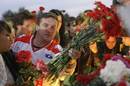 Fans of the Lokomotiv ice hockey team lay flowers and light candles