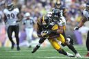 Cary Williams of the Baltimore Ravens tackles Antonio Brown of the Pittsburgh Steelers