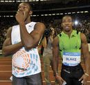 Yohan Blake and Usain Bolt look at the electric board