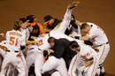 Robert Andino is mobbed by his team-mates