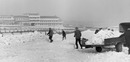 Teams of men clear the snow from Cheltenham racecourse