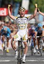 Mark Cavendish of Great Britain and Team Columbia-HTC crosses the finish line to win Stage 21 of the Tour de France